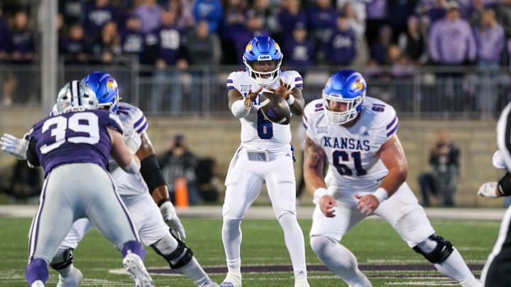 Oct 26, 2024; Manhattan, Kansas, USA; Kansas Jayhawks quarterback Jalon Daniels (6) takes the snap from center Bryce Foster (61) during the first quarter at Bill Snyder Family Football Stadium. Mandatory Credit: Scott Sewell-Imagn Images