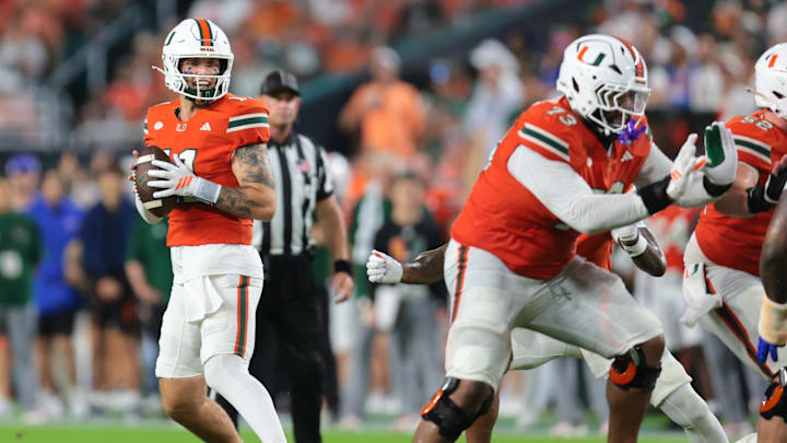 Sep 20, 2025; Miami Gardens, Florida, USA; Miami Hurricanes quarterback Carson Beck (11) moves inside the pocket against the Florida Gators during the first quarter at Hard Rock Stadium. Mandatory Credit: Sam Navarro-Imagn Images