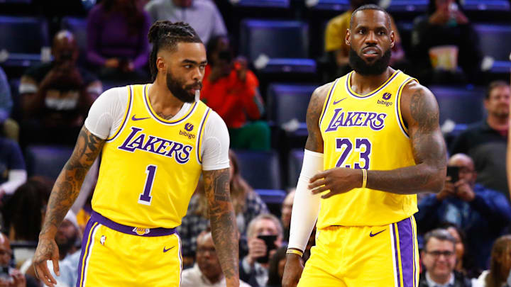 Mar 27, 2024; Memphis, Tennessee, USA; Los Angeles Lakers guard D'Angelo Russell (1) and forward LeBron James (23) wait for play to start against the Memphis Grizzlies at FedExForum. Mandatory Credit: Petre Thomas-Imagn Images