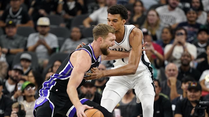 Nov 11, 2024; San Antonio, Texas, USA; Sacramento Kings center Domantas Sabonis (11) drives to the basket while defended by San Antonio Spurs center Victor Wembanyama (1) during the first half at Frost Bank Center. Mandatory Credit: Scott Wachter-Imagn Images