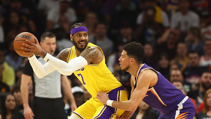 Apr 5, 2022; Phoenix, Arizona, USA; Los Angeles Lakers forward Carmelo Anthony (7) against Phoenix Suns guard Devin Booker (1) at Footprint Center. Mandatory Credit: Mark J. Rebilas-Imagn Images