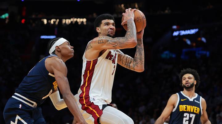 Dec 29, 2025; Miami, Florida, USA; Miami Heat center Kel'El Ware (7) drives to the basket against Denver Nuggets guard Peyton Watson (8) during the third quarter at Kaseya Center. Mandatory Credit: Sam Navarro-Imagn Images