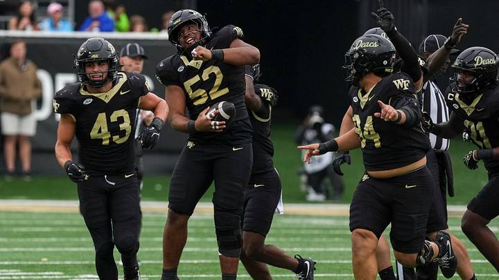 Oct 3, 2026; Winston-Salem, North Carolina, USA; Wake Forest Demon Deacons defensive lineman Dallas Afalava (52) celebrates his interception of Stanford Cardinal quarterback Davis Warren (8) during the second half at Allegacy Federal Credit Union Stadium. Mandatory Credit: Jim Dedmon-Imagn Images Oct 3, 2026; Winston-Salem, North Carolina, USA; Wake Forest Demon Deacons defensive lineman Dallas Afalava (52) celebrates his interception of Stanford Cardinal quarterback Davis Warren (8) during the second half at Allegacy Federal Credit Union Stadium. Mandatory Credit: Jim Dedmon-Imagn Images