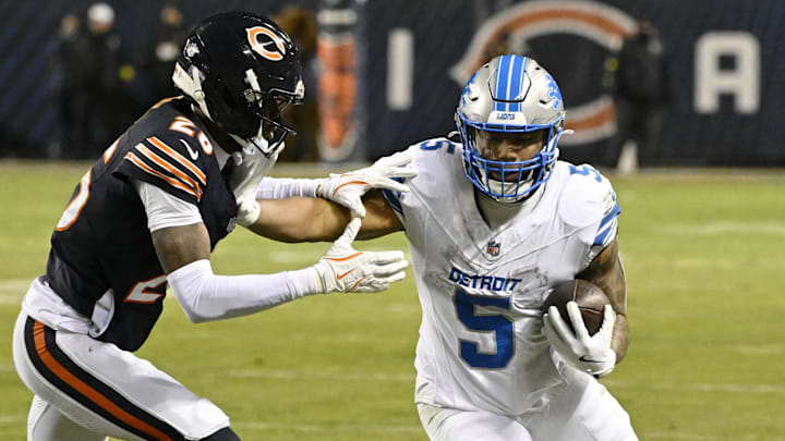 Jan 4, 2026; Chicago, Illinois, USA; Detroit Lions running back David Montgomery (5) runs with the ball against Chicago Bears cornerback Nahshon Wright (26) during the second half at Soldier Field. Mandatory Credit: Matt Marton-Imagn Images