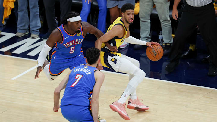 Jun 19, 2025; Indianapolis, Indiana, USA; Indiana Pacers guard Tyrese Haliburton (0) dribbles the ball defended by Oklahoma City Thunder guard Luguentz Dort (5) and forward Chet Holmgren (7) in the second quarter during game six of the 2025 NBA Finals at Gainbridge Fieldhouse. Mandatory Credit: Trevor Ruszkowski-Imagn Images