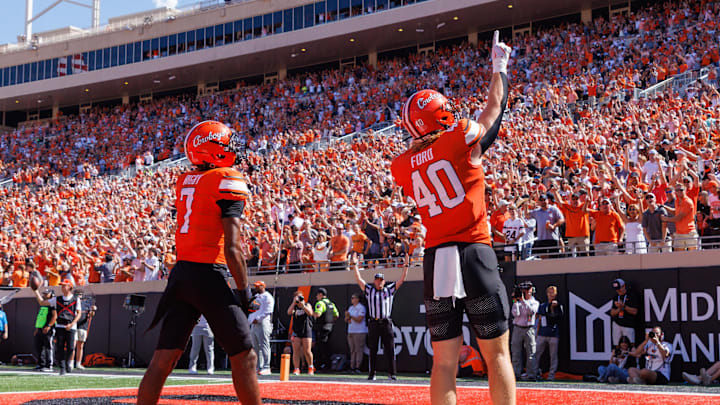 Sep 27, 2025; Stillwater, Oklahoma, USA; Oklahoma State Cowboys tight end Josh Ford (40) and Oklahoma State Cowboys wide receiver Shamar Rigby (7) celebrate in the end zone after a touchdown during the first half against the Baylor Bears at Boone Pickens Stadium. Mandatory Credit: William Purnell-Imagn Images