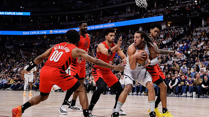 Feb 4, 2024; Denver, Colorado, USA; Denver Nuggets forward Aaron Gordon (50) controls the ball under pressure from Portland Trail Blazers guard Scoot Henderson (00) and center Deandre Ayton (2) and forward Toumani Camara (33) and guard Anfernee Simons (1) in the first quarter at Ball Arena. Mandatory Credit: Isaiah J. Downing-Imagn Images