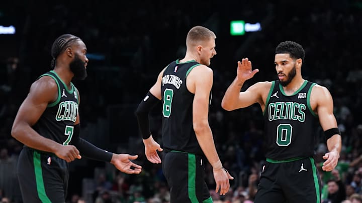 Nov 13, 2023; Boston, Massachusetts, USA; Boston Celtics forward Jayson Tatum (0), center Kristaps Porzingis (8) and guard Jaylen Brown (7) react after a play against th eNew York Knicks in the second quarter at TD Garden. Mandatory Credit: David Butler II-Imagn Images