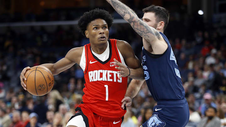 Feb 14, 2024; Memphis, Tennessee, USA; Houston Rockets forward Amen Thompson (1) drives to the basket as Memphis Grizzlies guard John Konchar (46) defends during the second half at FedExForum. Mandatory Credit: Petre Thomas-Imagn Images