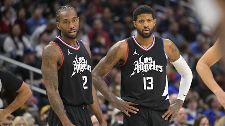 Los Angeles Clippers forward Kawhi Leonard (2) and forward Paul George (13) look on in the second half against the Detroit Pistons at Crypto.com Arena. Mandatory Credit: Jayne Kamin-Oncea-Imagn Images