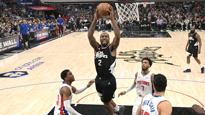 Feb 10, 2024; Los Angeles, California, USA;  Los Angeles Clippers forward Kawhi Leonard (2) drives past Detroit Pistons guard Jaden Ivey (23) and guard Troy Brown, jr. (7) for a dunk in the second half at Crypto.com Arena. Mandatory Credit: Jayne Kamin-Oncea-Imagn Images
