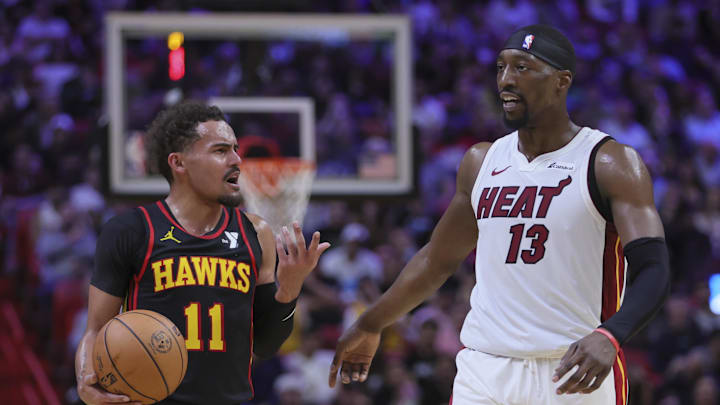 Dec 22, 2023; Miami, Florida, USA; Atlanta Hawks guard Trae Young (11) and Miami Heat center Bam Adebayo (13) talk during the second quarter at Kaseya Center. Mandatory Credit: Sam Navarro-Imagn Images