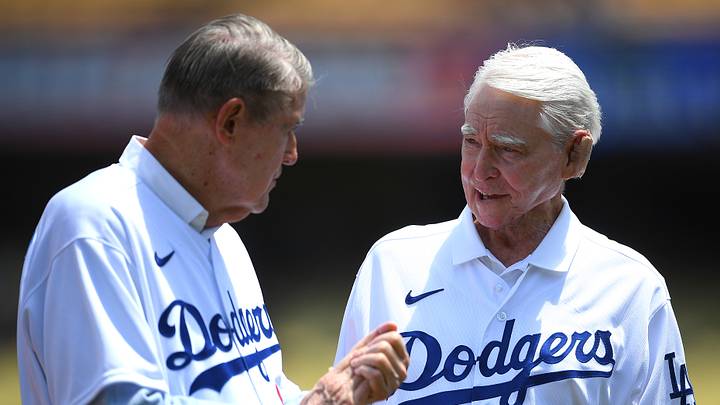 Former owner of the Los Angeles Dodgers Peter O'Malley talks with former general manager Fred Claire as the 1981 team was honored during pregame ceremonies at Dodger Stadium on July 25, 2021. Former owner of the Los Angeles Dodgers Peter O'Malley talks with former general manager Fred Claire as the 1981 team was honored during pregame ceremonies at Dodger Stadium on July 25, 2021.