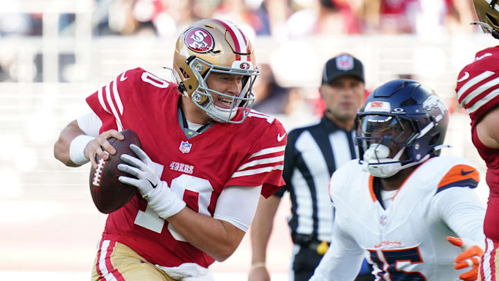 Aug 9, 2025; Santa Clara, California, USA;  San Francisco 49ers quarterback Mac Jones (10) scrambles away from Denver Broncos outside linebacker Nik Bonitto (15) in the first quarter at Levi's Stadium. Mandatory Credit: David Gonzales-Imagn Images
