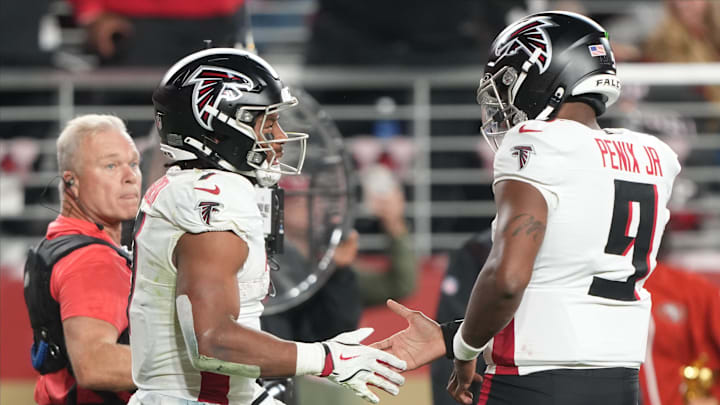 Oct 19, 2025; Santa Clara, California, USA; Atlanta Falcons running back Bijan Robinson (7) high-fives Atlanta Falcons quarterback Michael Penix Jr. (9) after a touchdown during the third quarter against the San Francisco 49ers at Levi's Stadium. Mandatory Credit: Darren Yamashita-Imagn Images