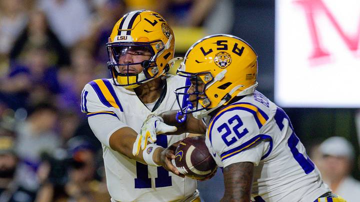 Nov 22, 2025; Baton Rouge, Louisiana, USA;  LSU Tigers quarterback Michael van Buren Jr. (11) hands the ball off to running back Harlem Berry (22) against the Western Kentucky Hilltoppers during the first half at Tiger Stadium. Mandatory Credit: Stephen Lew-Imagn Images