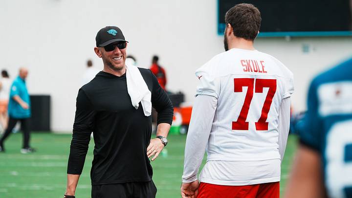 Jacksonville Jaguars head coach Liam Coen has a laugh with Tampa Bay Buccaneers offensive tackle Justin Skule (77) after a joint Buccaneers‑Jaguars NFL practice Wednesday, August 26, 2026 at the Miller Electric Center in Jacksonville, Fla. [Doug Engle/Florida Times-Union]