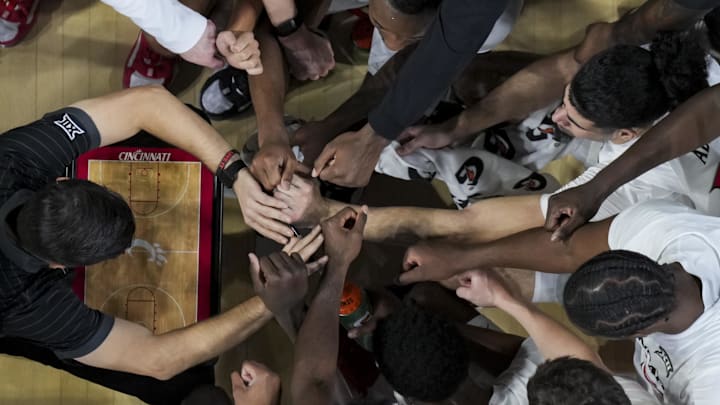 Nov 26, 2025; Cincinnati, Ohio, USA;  Cincinnati Bearcats head coach Wes Miller leads a team huddle during a stop in play against the Eastern Michigan Eagles in the second half at Fifth Third Arena. Mandatory Credit: Aaron Doster-Imagn Images