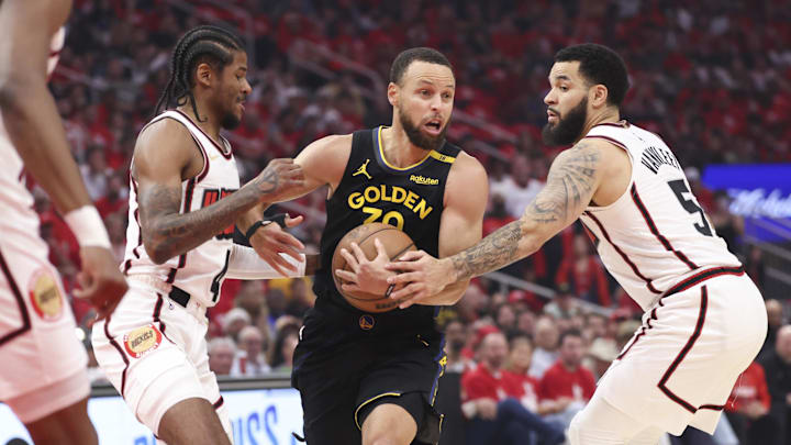 May 4, 2025; Houston, Texas, USA; Golden State Warriors guard Stephen Curry (30) controls the ball as Houston Rockets guard Jalen Green (4) and guard Fred VanVleet (5) defend during the first quarter of game seven of the first round for the 2025 NBA Playoffs at Toyota Center. Mandatory Credit: Troy Taormina-Imagn Images