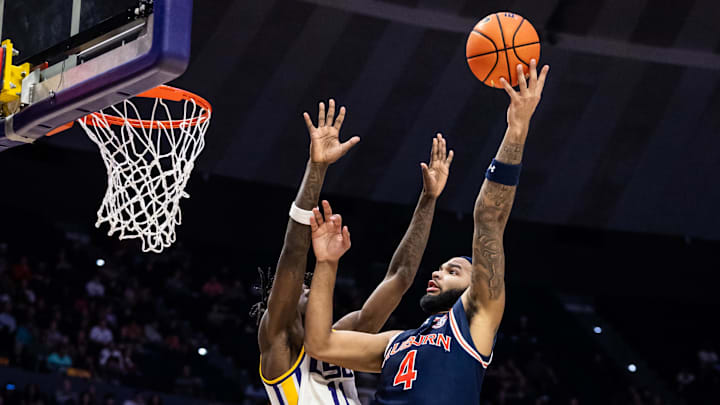 Jan 29, 2025; Baton Rouge, Louisiana, USA;  Auburn Tigers forward Johni Broome (4) misses a jump shot against LSU Tigers forward Corey Chest (11) during the second half at Pete Maravich Assembly Center. Mandatory Credit: Stephen Lew-Imagn Images