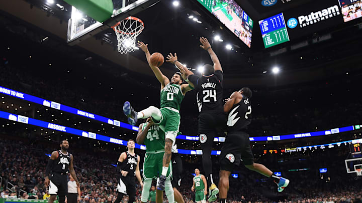 Boston Celtics forward Jayson Tatum (0) is fouled by LA Clippers forward Norman Powell (24) during the second half at TD Garden. Mandatory Credit: Bob DeChiara-Imagn Images