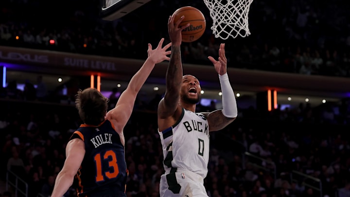 Nov 8, 2024; New York, New York, USA; Milwaukee Bucks guard Damian Lillard (0) is fouled by New York Knicks guard Tyler Kolek (13) as he drives to the basket during the second quarter at Madison Square Garden. Mandatory Credit: Brad Penner-Imagn Images