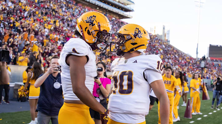 Nov 30, 2024; Tucson, Arizona, USA; Arizona State Sun Devils wide receiver Xavier Guillory (1) celebrates a touchdown with quarterback Sam Leavitt (10) against the Arizona Wildcats in the second half during the Territorial Cup at Arizona Stadium. Mandatory Credit: Mark J. Rebilas-Imagn Images
