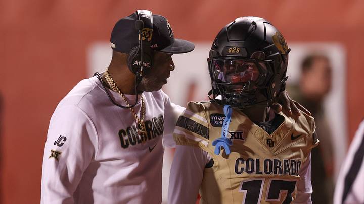 Oct 25, 2025; Salt Lake City, Utah, USA; Colorado Buffaloes head coach Deion Sanders speaks with Colorado Buffaloes wide receiver Isaiah Hardge (17) before the game against the Utah Utes at Rice-Eccles Stadium. Mandatory Credit: Rob Gray-Imagn Images