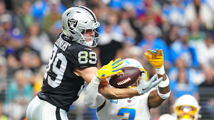 Jan 5, 2025; Paradise, Nevada, USA; Las Vegas Raiders tight end Brock Bowers (89) and Los Angeles Chargers safety Derwin James Jr. (3) reach for a pass during the fourth quarter at Allegiant Stadium. Mandatory Credit: Stephen R. Sylvanie-Imagn Images Jan 5, 2025; Paradise, Nevada, USA; Las Vegas Raiders tight end Brock Bowers (89) and Los Angeles Chargers safety Derwin James Jr. (3) reach for a pass during the fourth quarter at Allegiant Stadium. Mandatory Credit: Stephen R. Sylvanie-Imagn Images