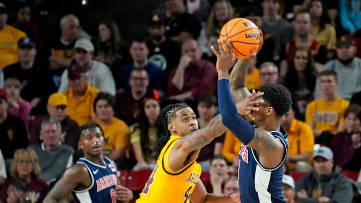 Arizona State Sun Devils guard Adam Miller (44) guards Arizona Wildcats guard Caleb Love (1) during a Big 12 men's basketball game at Desert Financial Arena on Feb. 1, 2025, in Tempe.