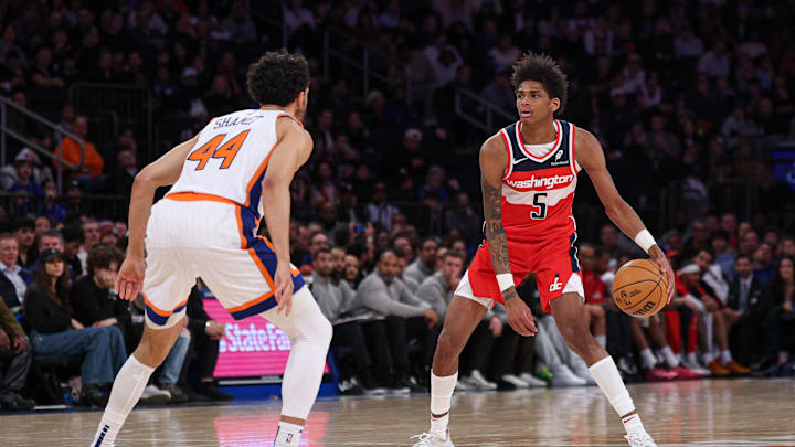 Washington Wizards guard AJ Johnson dribbles as New York Knicks guard Landry Shamet defends. Mandatory Credit: Vincent Carchietta-Imagn Images