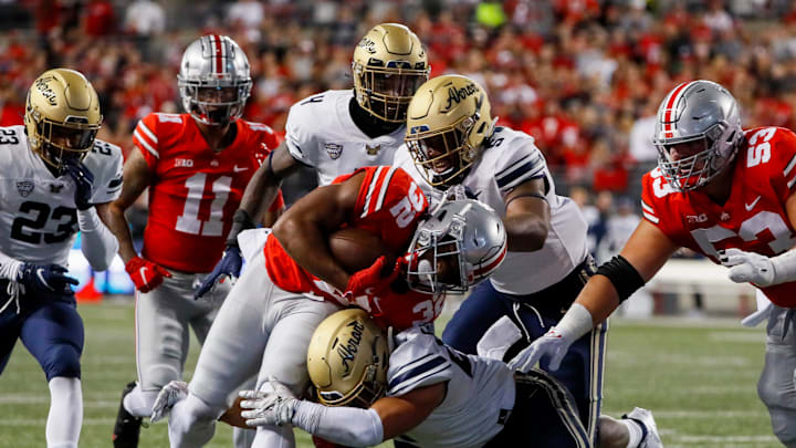 Ohio State Buckeyes running back TreVeyon Henderson (32) powers downfield as Akron Zips linebacker Bubba Arslanian (27) makes the tackle during the first quarter of a NCAA Division I football game between the Ohio State Buckeyes and the Akron Zips on Saturday, Sept. 25, 2021 at Ohio Stadium in Columbus, Ohio.

Cfb Akron Zips At Ohio State Buckeyes