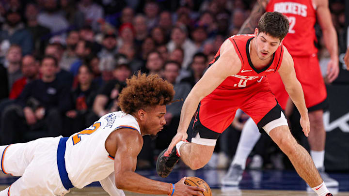 Feb 3, 2025; New York, New York, USA; New York Knicks guard Miles McBride (2) battles for a loose ball against Houston Rockets guard Reed Sheppard (15) during the first half at Madison Square Garden. Mandatory Credit: Vincent Carchietta-Imagn Images