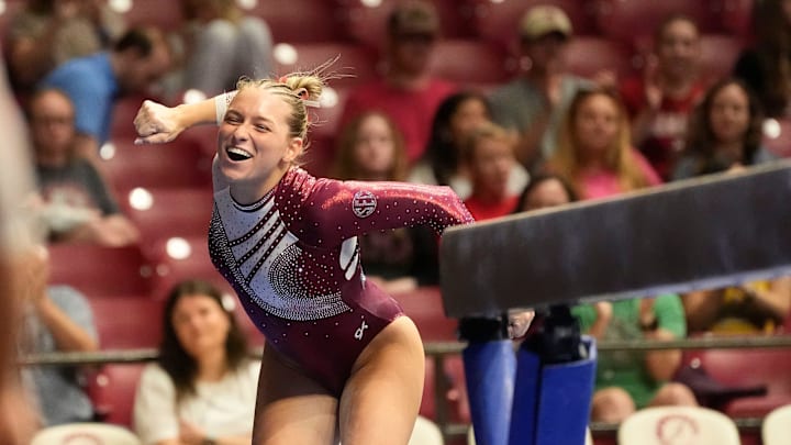 Apr 6, 2025; Tuscaloosa, AL, USA; Alabama's Rachel Rybicki celebrates after landing her beam dismount at Coleman Coliseum during the NCAA Gymnastics Tuscaloosa Regional. Florida won the event wtih a 197.700 and Alabama placed second to advance with a 197.675.