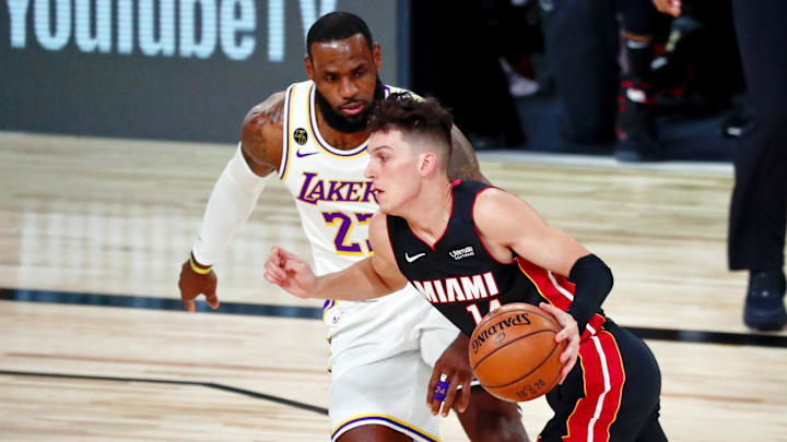 Oct 4, 2020; Orlando, Florida, USA; Miami Heat guard Tyler Herro (14) drives to the basket while defended by Los Angeles Lakers forward LeBron James (23) during the first quarter of game three of the 2020 NBA Finals at AdventHealth Arena. Mandatory Credit: Kim Klement-Imagn Images