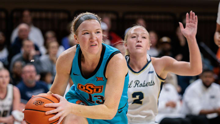 Nov 9, 2025; Stillwater, Oklahoma, USA; Oklahoma State Cowgirls guard Haleigh Timmer (13) drives to the basket during the first half against the Oral Roberts Golden Eagles at Gallagher-Iba Arena. Mandatory Credit: William Purnell-Imagn Images