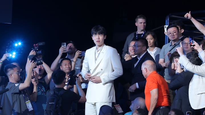 Jun 25, 2025; Yang Hansen makes his way to the stage after being selected as the 16th pick of the 2025 NBA Draft. Credit: Brad Penner-Imagn Images