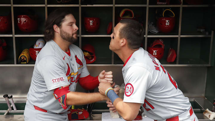 Jul 24, 2024; Pittsburgh, Pennsylvania, USA;  St. Louis Cardinals right fielder Alec Burleson (left) and left fielder Lars Nootbaar (21) perform a pre-game ritual before playing the Pittsburgh Pirates at PNC Park. Mandatory Credit: Charles LeClaire-Imagn Images