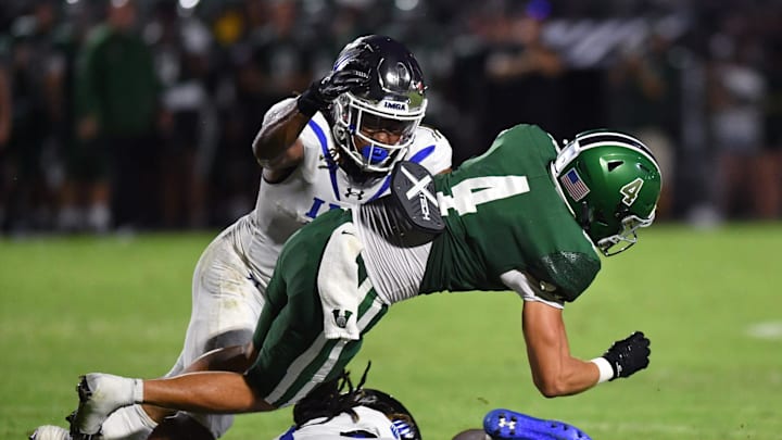 Venice wide receiver Ryan Matulevich gets caught between IMG Academy defensive backs Zech Fort (top) and Major Preston. Venice played host to IMG Academy on Friday, Oct. 4, 2024.