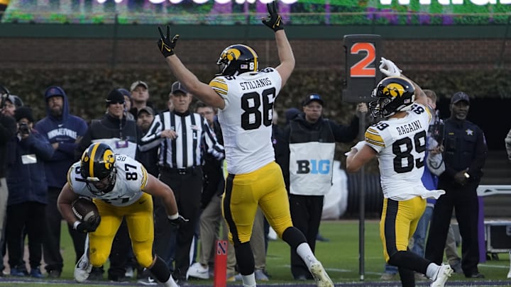 Nov 4, 2023; Chicago, Illinois, USA; Iowa Hawkeyes tight end Addison Ostrenga (87) catches a touchdown pass against the Northwestern Wildcats during the second half at Wrigley Field. Mandatory Credit: David Banks-Imagn Images