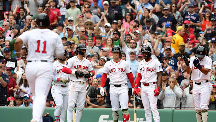 May 18, 2025; Boston, Massachusetts, USA; Boston Red Sox left fielder Jarren Duran (16) center fielder Ceddanne Rafaela (3) and second baseman David Hamilton (17) wait at home to congratulate designated hitter Rafael Devers (11) after hitting a grand slam during the fourth inning against the Atlanta Braves at Fenway Park. Mandatory Credit: Bob DeChiara-Imagn Images