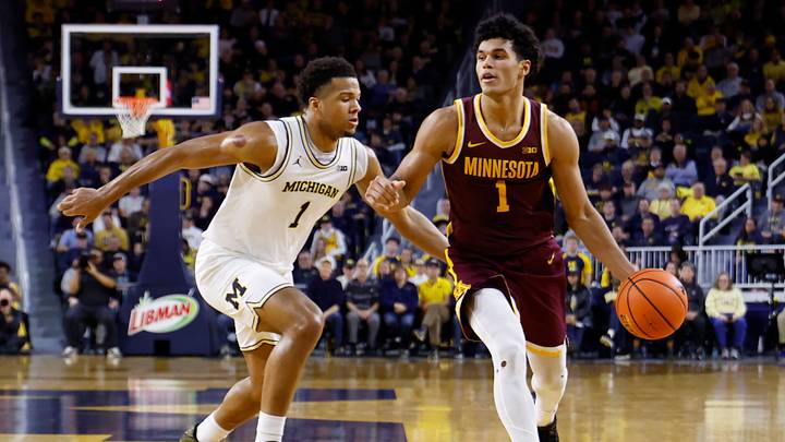 Feb 24, 2026; Ann Arbor, Michigan, USA; Minnesota Golden Gophers guard Isaac Asuma (1) dribbles against Michigan Wolverines guard Trey McKenney (1) in the second half at Crisler Center. Mandatory Credit: Rick Osentoski-Imagn Images