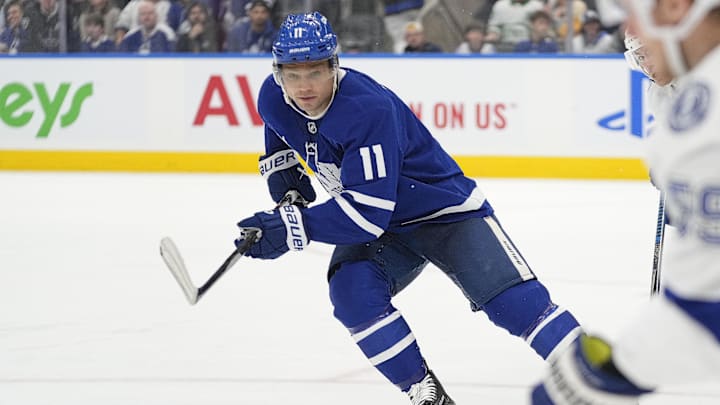 Oct 21, 2024; Toronto, Ontario, CAN; Toronto Maple Leafs forward Max Domi (11) defends against Tampa Bay Lightning forward Jake Guentzel (59) during the third period at Scotiabank Arena. Mandatory Credit: John E. Sokolowski-Imagn Images