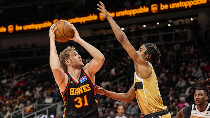 Feb 24, 2026; Atlanta, Georgia, USA; Atlanta Hawks center Jock Landale (31) shoots over Washington Wizards guard Tre Johnson (12) during the second half at State Farm Arena. Mandatory Credit: Dale Zanine-Imagn Images