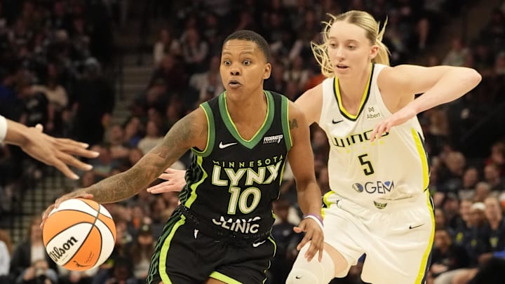 May 21, 2025; Minneapolis, Minnesota, USA; Minnesota Lynx guard Courtney Williams (10) dribbles past Dallas Wings guard Paige Bueckers (5) in the third quarter at Target Center. Mandatory Credit: Bruce Kluckhohn-Imagn Images