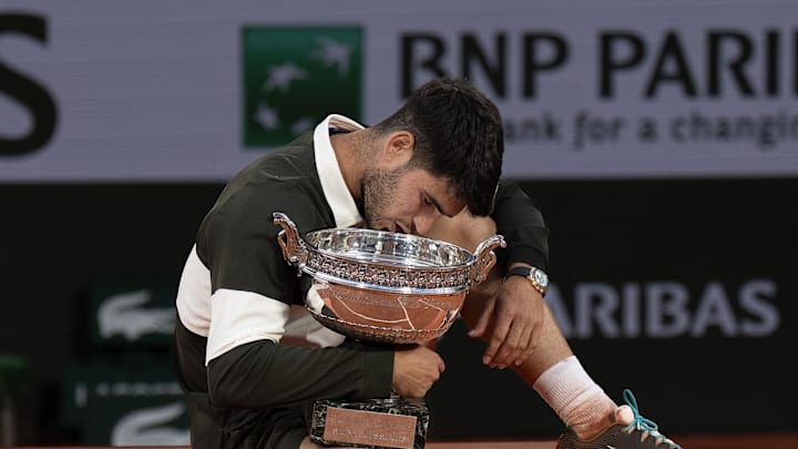 Jun 8, 2025; Paris, FR; Carlos Alcaraz of Spain poses with the trophy after winning the men’s singles final against Jannik Sinner