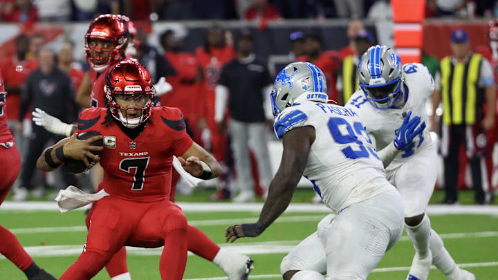Nov 10, 2024; Houston, Texas, USA; Houston Texans quarterback C.J. Stroud (7) scrambles from Detroit Lions defensive end Josh Paschal (93) in the second half at NRG Stadium. Mandatory Credit: Thomas B. Shea-Imagn Images