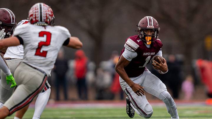Harper Woods wide receiver Dakota Guerrant runs the ball against the Dearborn Divine Child defense during a Division 4 regional final at John Glenn High School in Westland on Saturday, Nov. 15, 2025. Harper Woods wide receiver Dakota Guerrant runs the ball against the Dearborn Divine Child defense during a Division 4 regional final at John Glenn High School in Westland on Saturday, Nov. 15, 2025.