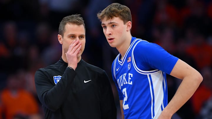 Feb 5, 2025; Syracuse, New York, USA; Duke Blue Devils head coach Jon Scheyer talks with guard Cooper Flagg (2) against the Syracuse Orange during the first half at the JMA Wireless Dome. Mandatory Credit: Rich Barnes-Imagn Images