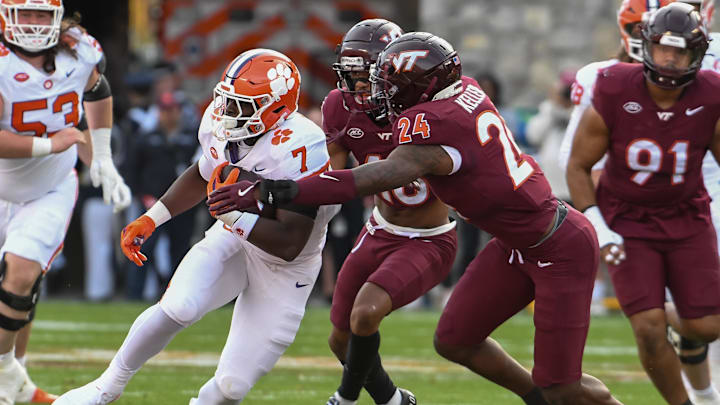 Nov 9, 2024; Blacksburg, Virginia, USA;  Clemson Tigers running back Phil Mafah (7) runs the ball as Virginia Tech Hokies linebacker Jaden Keller (24) reaches for the tackle during the second quarter at Lane Stadium. Mandatory Credit: Brian Bishop-Imagn Images